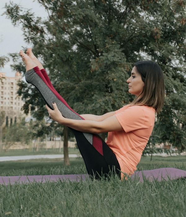 Woman in a calm yoga pose, embodying balance and serenity.